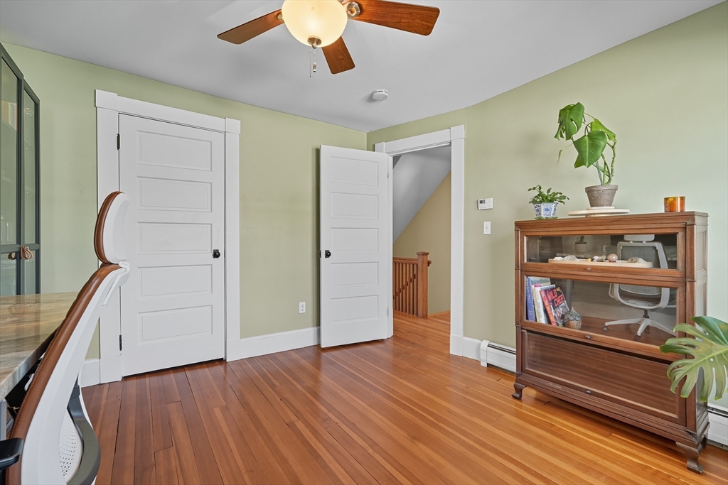 5 Grant Street, Unit 5 Easthampton, MA 01027 - Photo 19 of 36 a room with wooden floor and ceiling fan