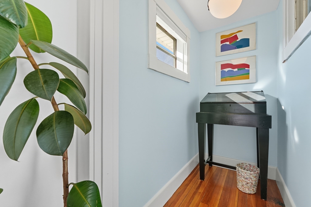 5 Grant Street, Unit 5 Easthampton, MA 01027 - Photo 24 of 36 a room with painting on the wall and a potted plant