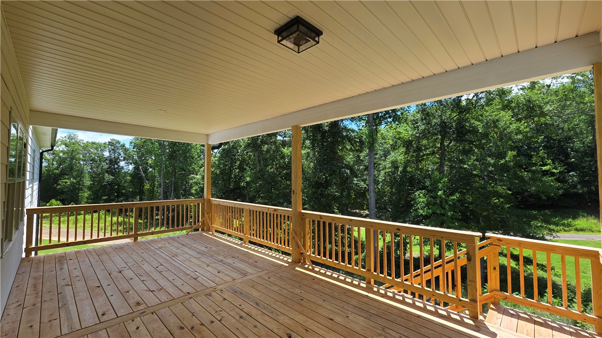 243 Holly Br Road Piedmont, SC 29673 - Photo 21 of 21 A spacious, naturally illuminated deck with wooded views offers a serene outdoor retreat.