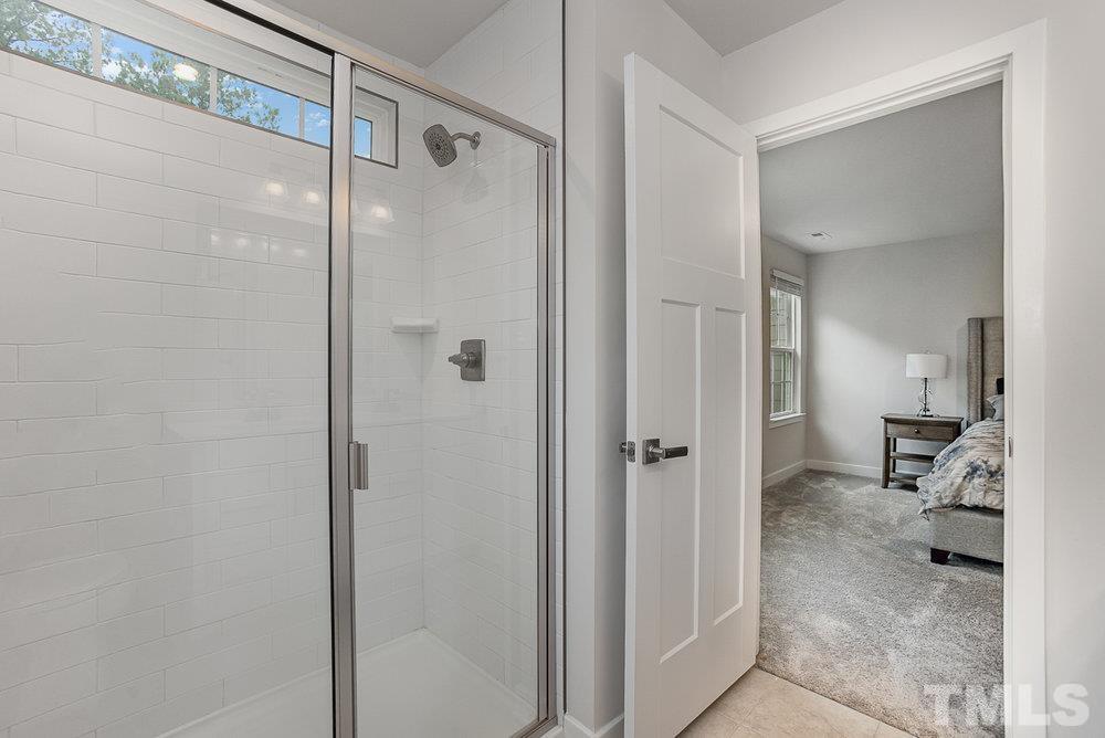 4760 Randall Road Durham, NC 27707 - Photo 14 of 23 a bathroom with a shower and a glass door