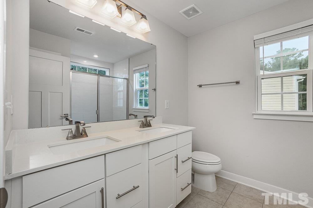 4760 Randall Road Durham, NC 27707 - Photo 15 of 23 a bathroom with a toilet sink and mirror
