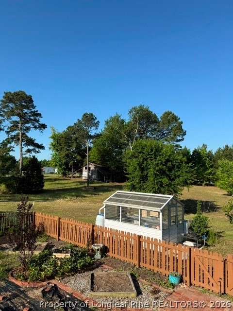 1284 L Cooper Road Cameron, NC 28326 - Photo 21 of 24 a front view of a house with a garden