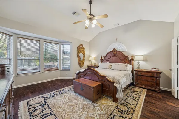 a spacious bedroom with a bed and a window