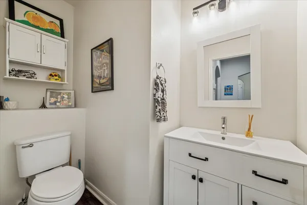 a bathroom with a toilet sink and mirror