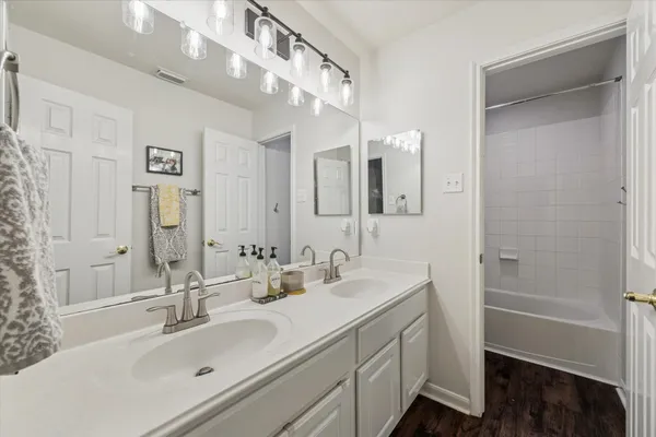 a bathroom with a double vanity sink mirror and double