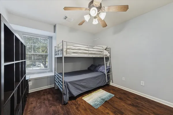 a bedroom with a bunk bed and a chandelier