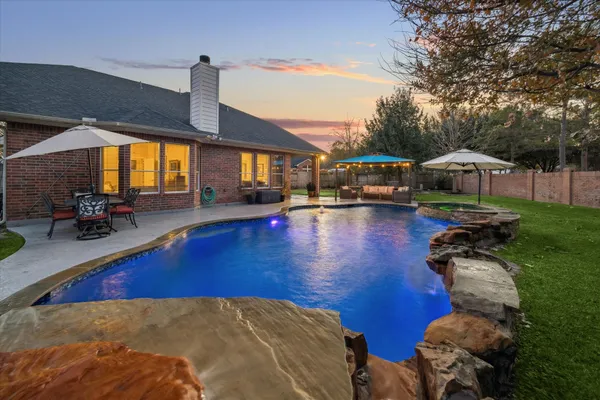 a view of a patio with swimming pool table and chairs