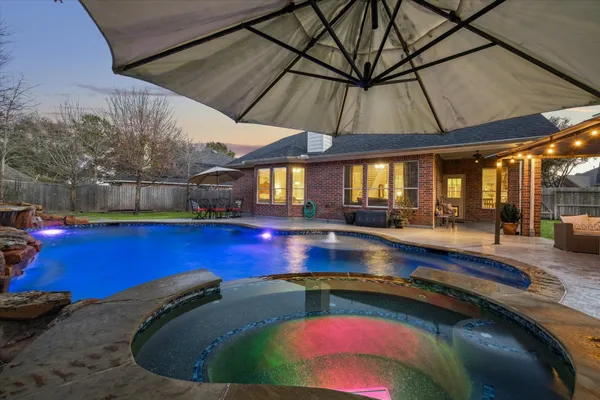 a view of swimming pool with a chair and tables