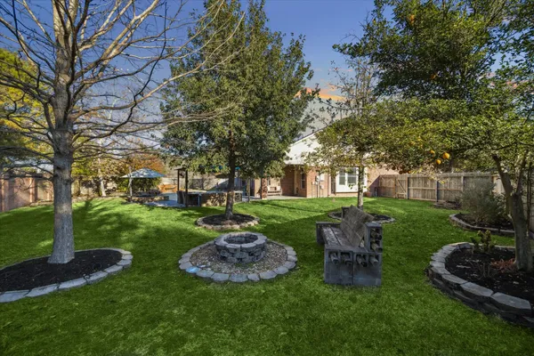 a view of a garden with large trees