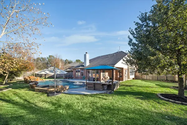 a swimming pool view with a outdoor seating