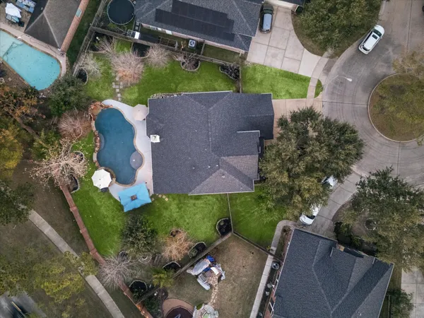 an aerial view of a house with a yard and outdoor seating