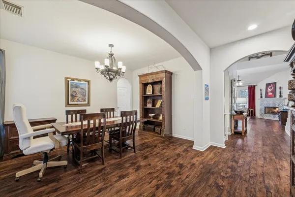 a view of a dining room with furniture and chandelier