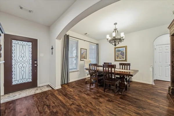 a view of a dining room with furniture and chandelier