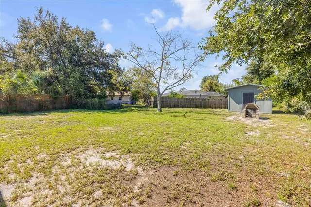 a view of a swimming pool with a lawn chairs under an umbrella