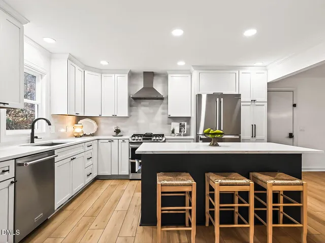 a large kitchen with cabinets and stainless steel appliances