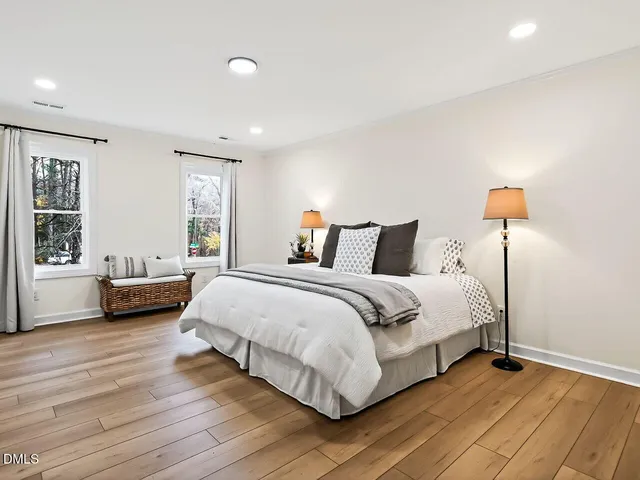 a bedroom with a bed and a large window