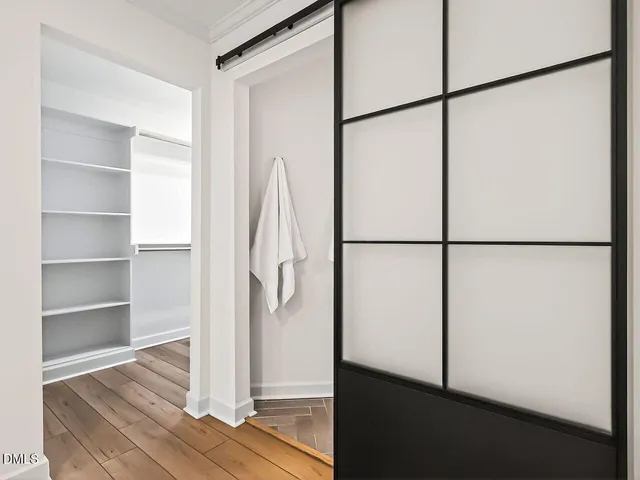 a view of walk in closet with empty racks