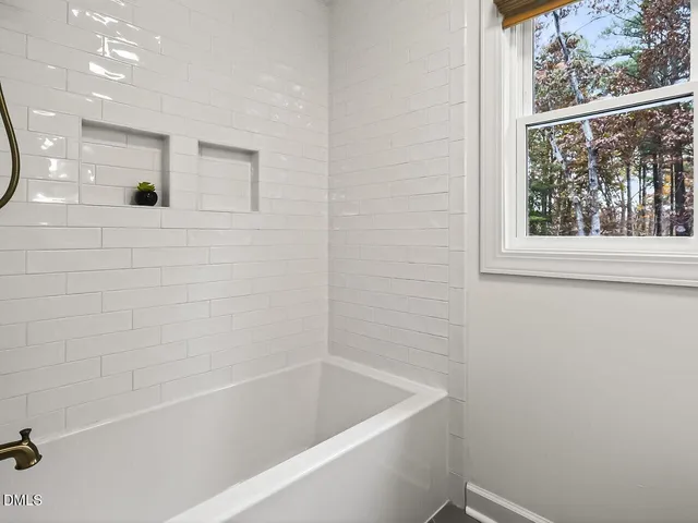 a bathroom with a bathtub and shower