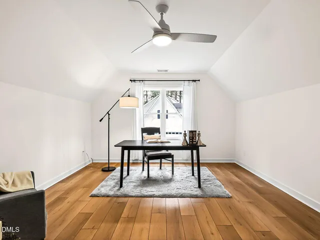 a view of a livingroom with furniture wooden floor and a window