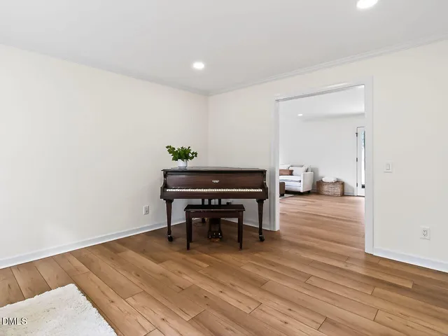 a room with wooden floor and furniture