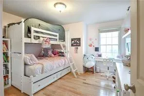 a bedroom with a bed and large window