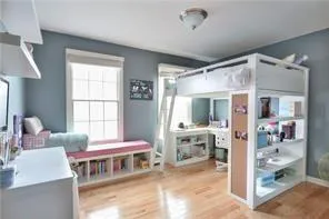 a bedroom with furniture and a window