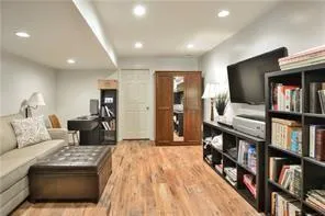 a living room with furniture and a book shelf