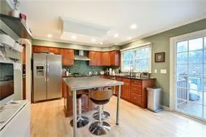 a kitchen with stainless steel appliances granite countertop a refrigerator a sink a stove and island