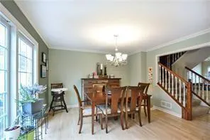 a view of a dining room with furniture and a chandelier