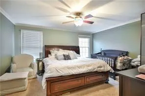 a bedroom with a bed and a chandelier