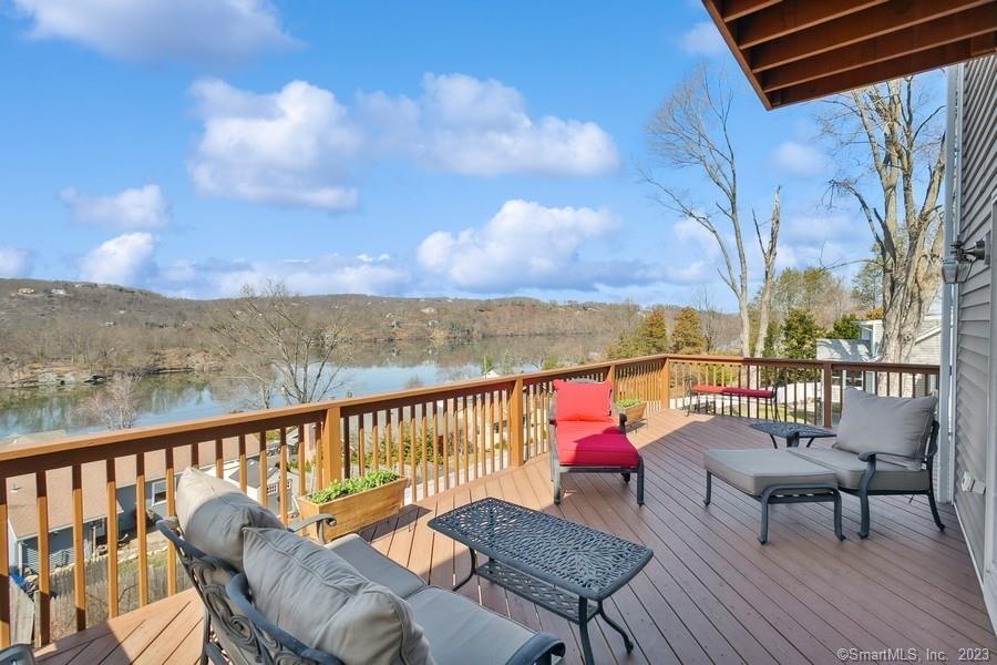 a sitting area with furniture on wooden deck