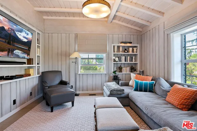 a view of a dining room with furniture and a chandelier