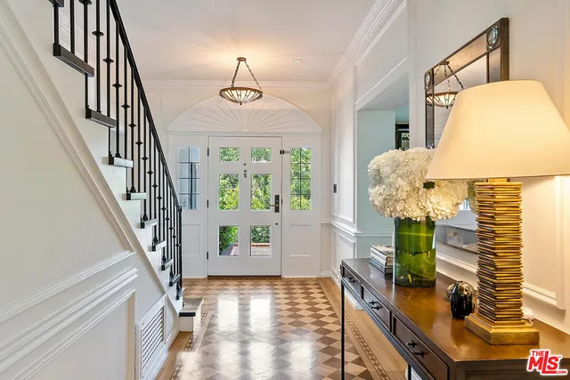 a dining room with furniture a chandelier and wooden floor