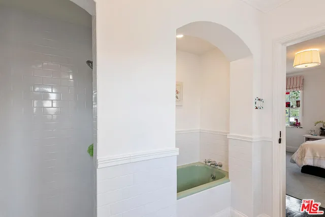 a spacious bedroom with a bed and a table in it