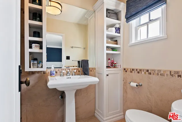 a group of people sitting in front of a house