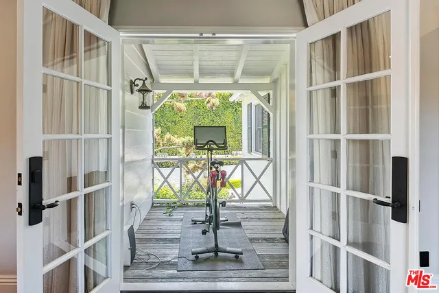 a view of a roof deck with wooden fence and plants