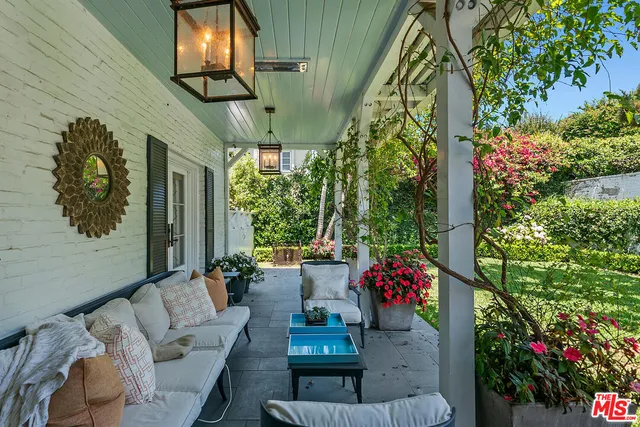 a backyard of a house with yard and outdoor seating