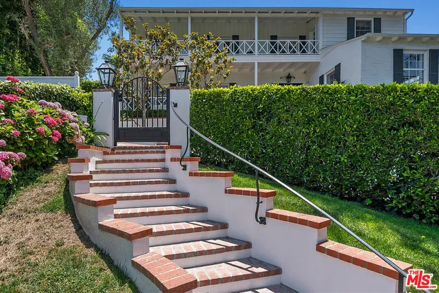 a living room with furniture a fireplace and a large window