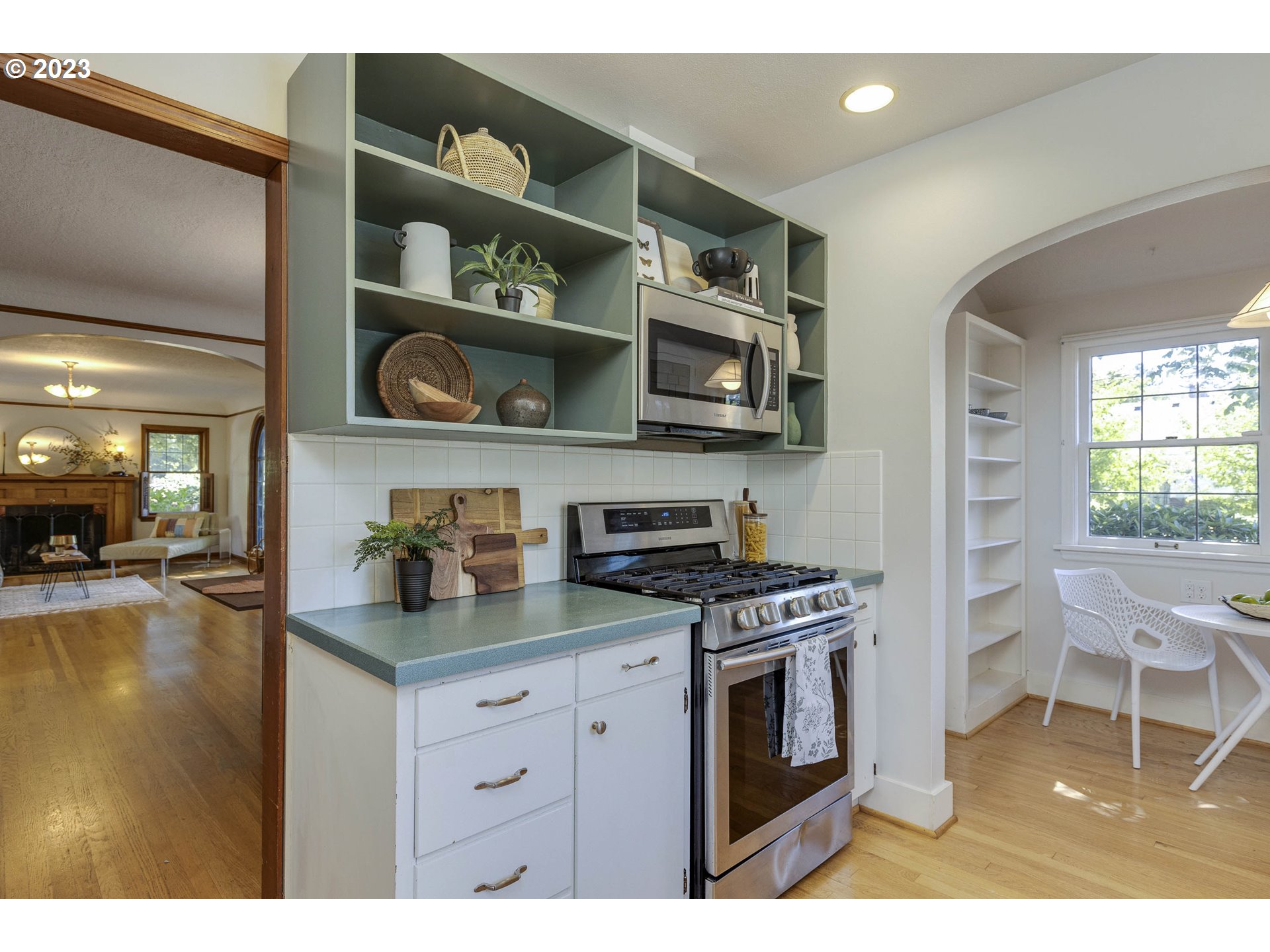 3227 Southeast Lambert Street Portland, OR 97202 - Photo 14 of 44 a kitchen with stainless steel appliances a stove a microwave and cabinets