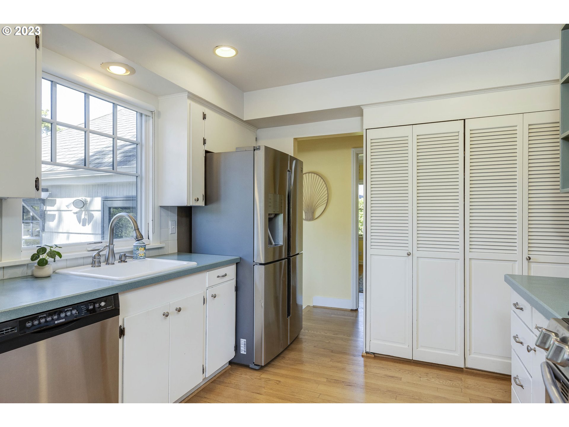 3227 Southeast Lambert Street Portland, OR 97202 - Photo 18 of 44 a kitchen with a refrigerator a sink and a window