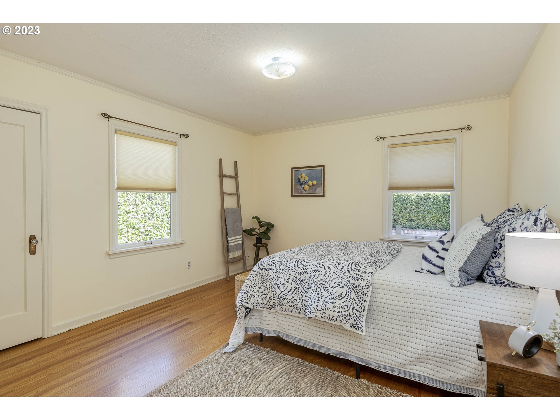 3227 Southeast Lambert Street Portland, OR 97202 - Photo 22 of 44 a bedroom with a bed and a window