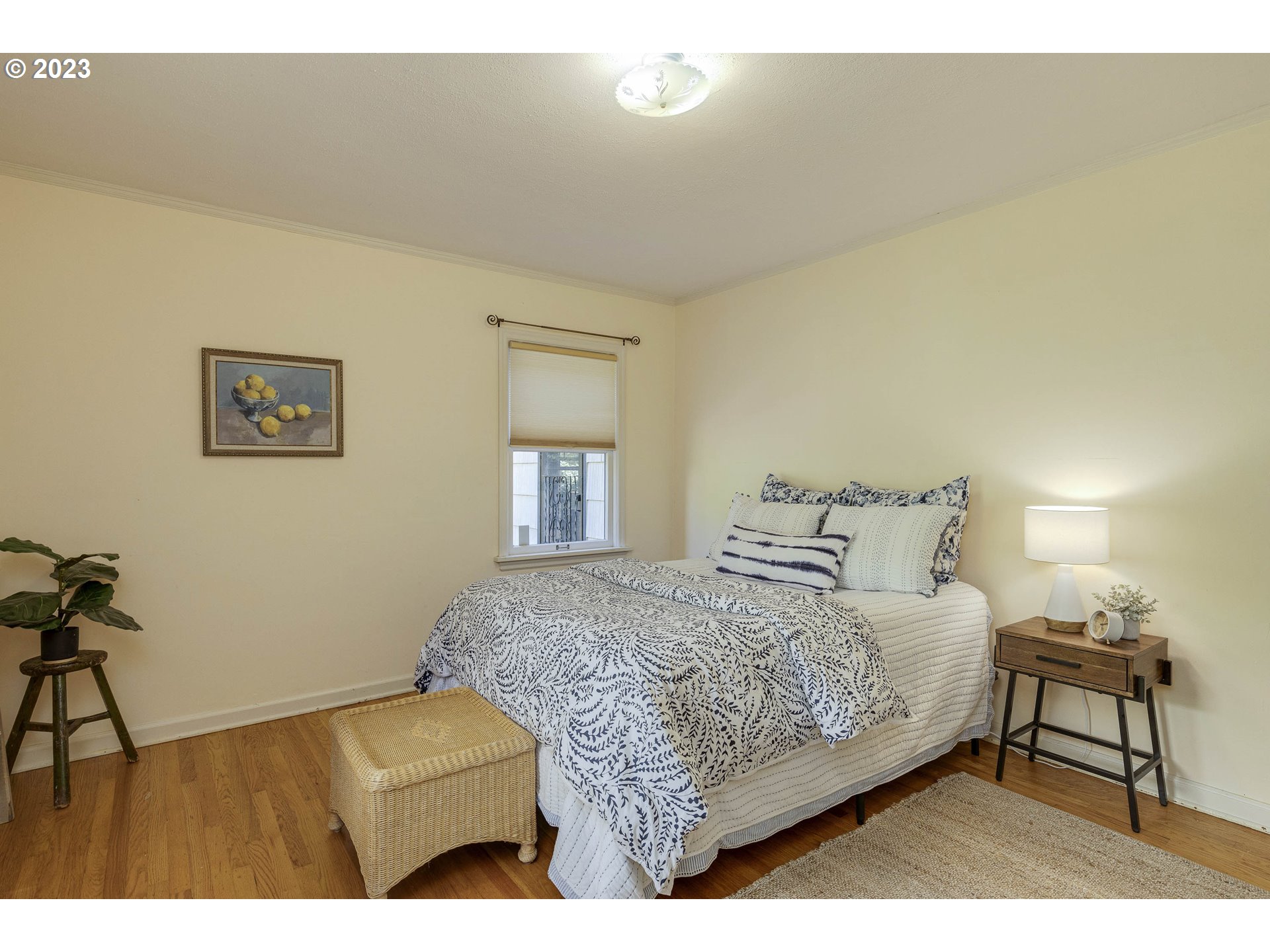 3227 Southeast Lambert Street Portland, OR 97202 - Photo 23 of 44 a bedroom with a bed window and a table
