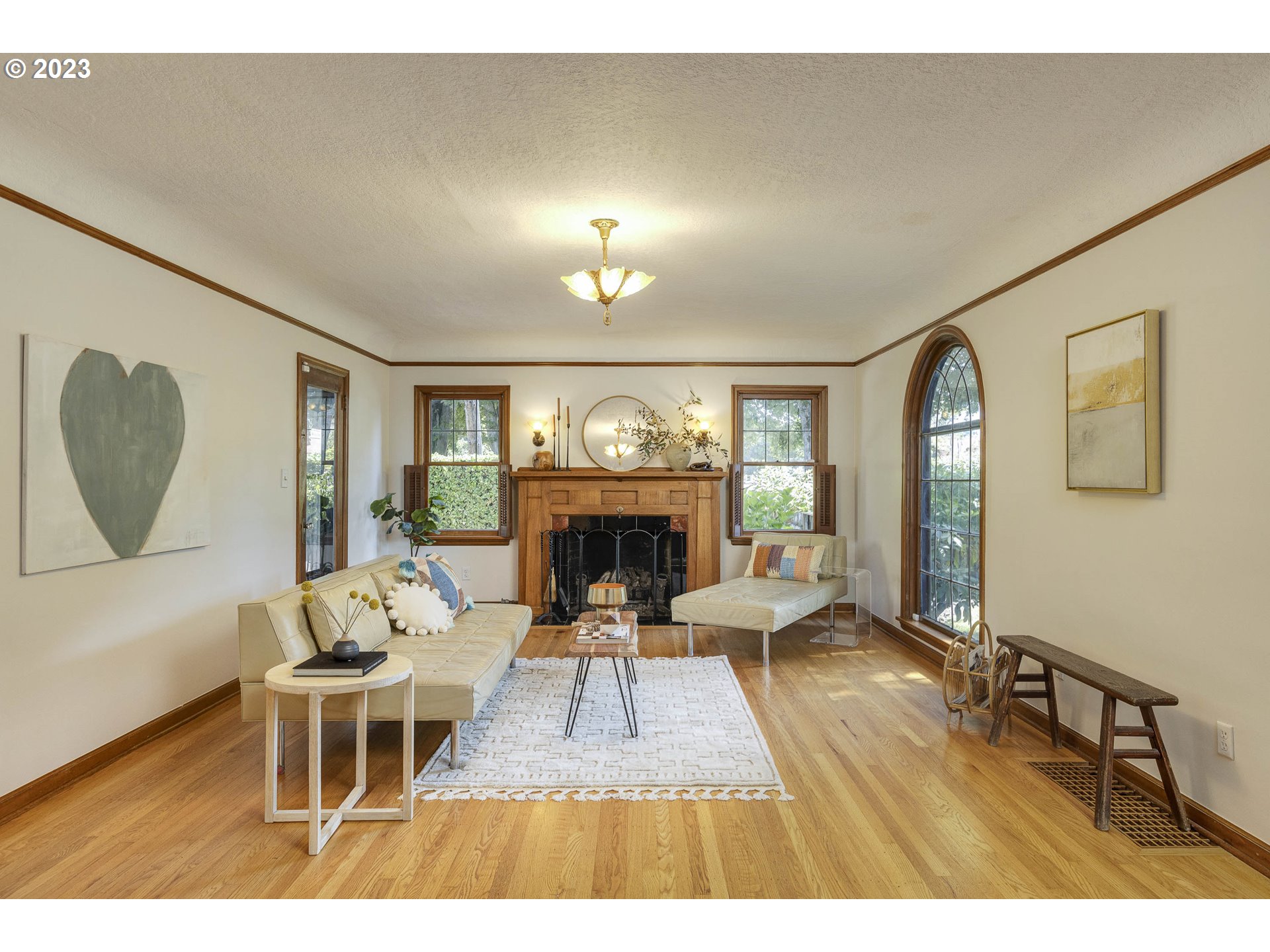 3227 Southeast Lambert Street Portland, OR 97202 - Photo 8 of 44 a living room with furniture a fireplace and a large mirror