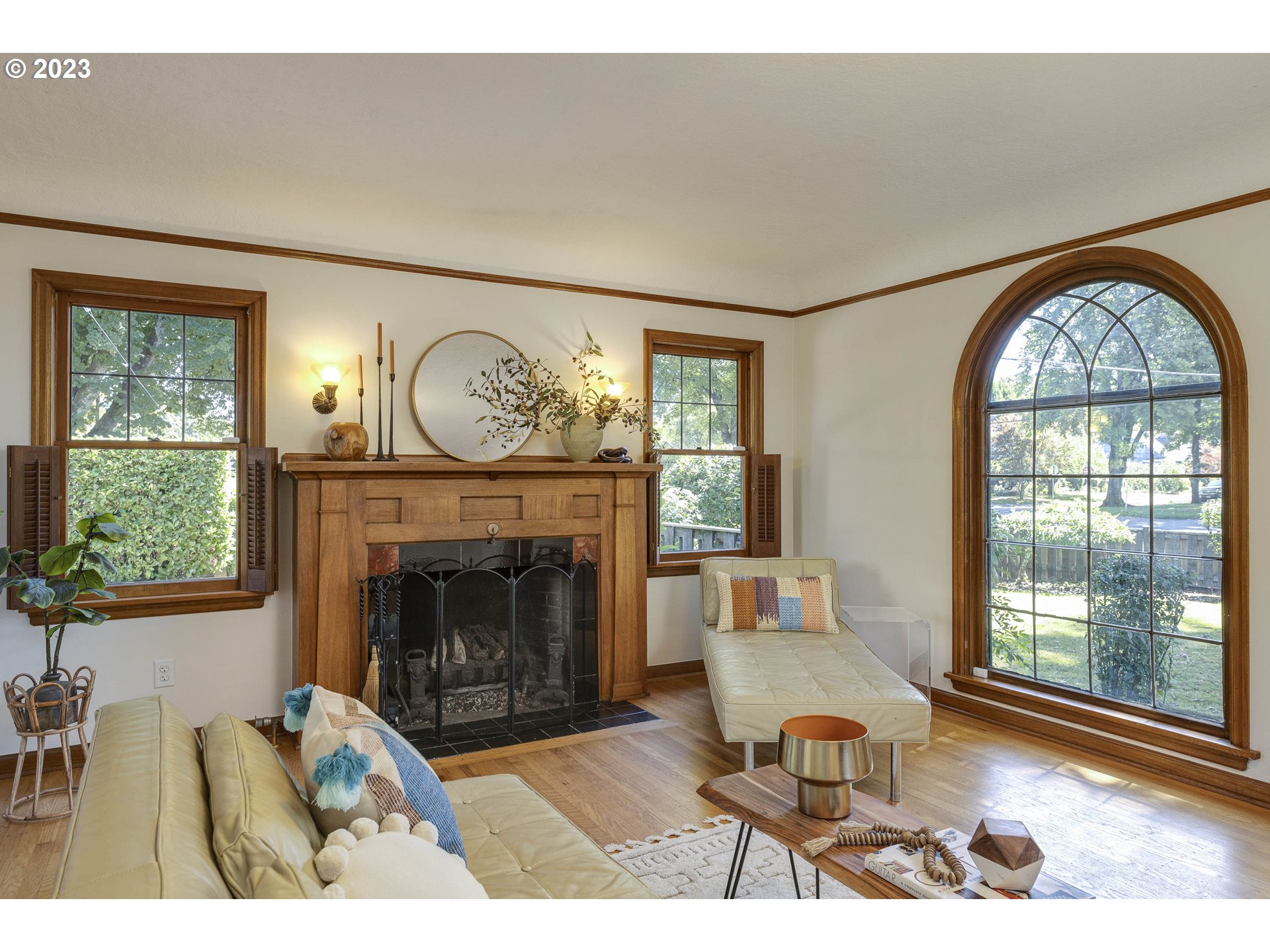 3227 Southeast Lambert Street Portland, OR 97202 - Photo 9 of 44 a living room with furniture a fireplace and a large window
