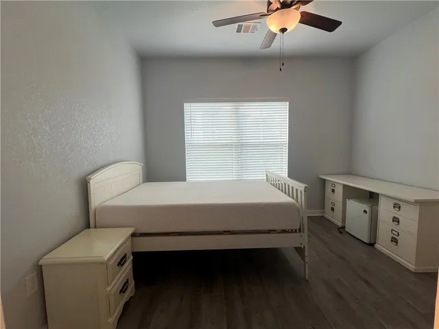 a bed sitting in a bedroom next to a window