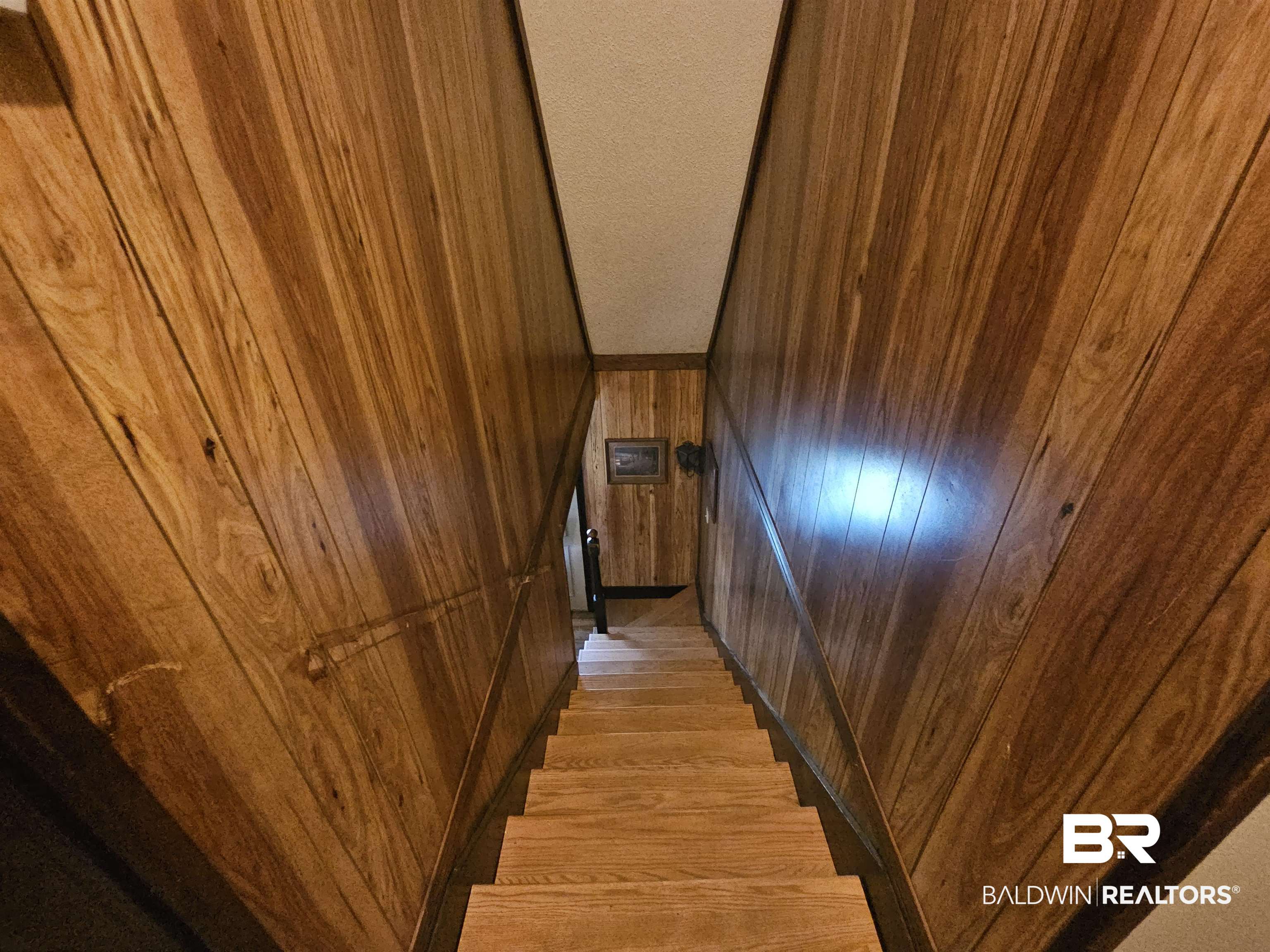 1818 Old Fannie Road Flomaton, AL 36441 - Photo 19 of 20 Stairway with wooden walls and wood finished floors