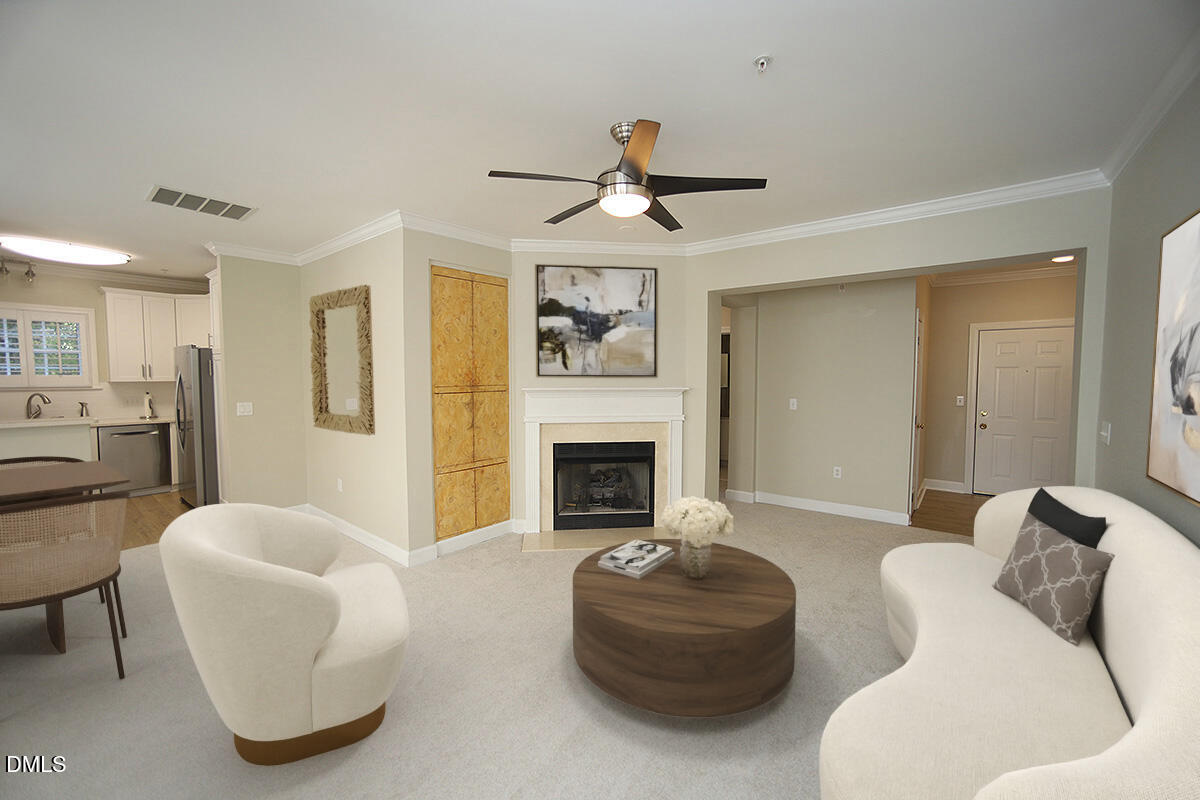 100 Northbrook Drive, Unit 207 Raleigh, NC 27609 - Photo 11 of 39 a living room with furniture a fireplace and a ceiling fan