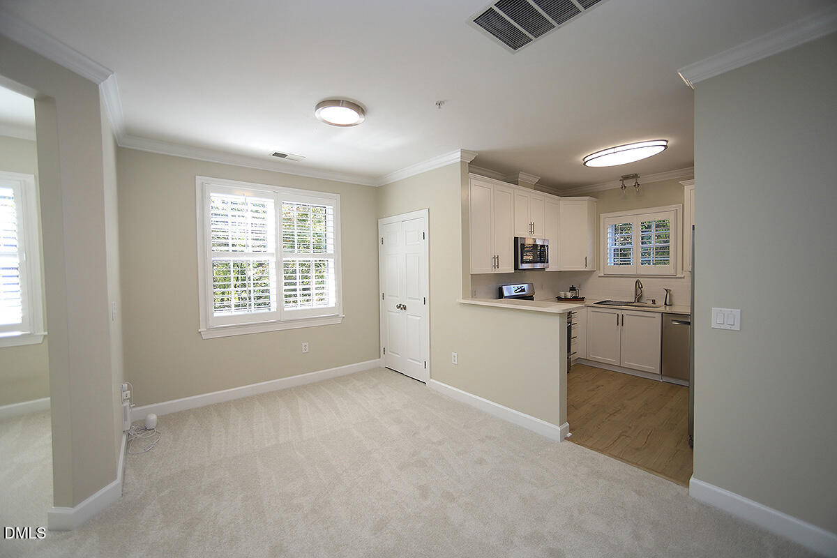 100 Northbrook Drive, Unit 207 Raleigh, NC 27609 - Photo 12 of 39 a kitchen with refrigerator and window
