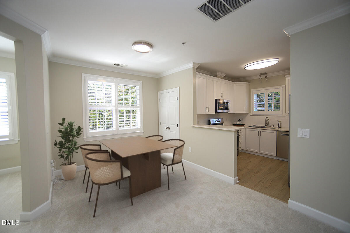 100 Northbrook Drive, Unit 207 Raleigh, NC 27609 - Photo 13 of 39 a kitchen with a table and chairs in it