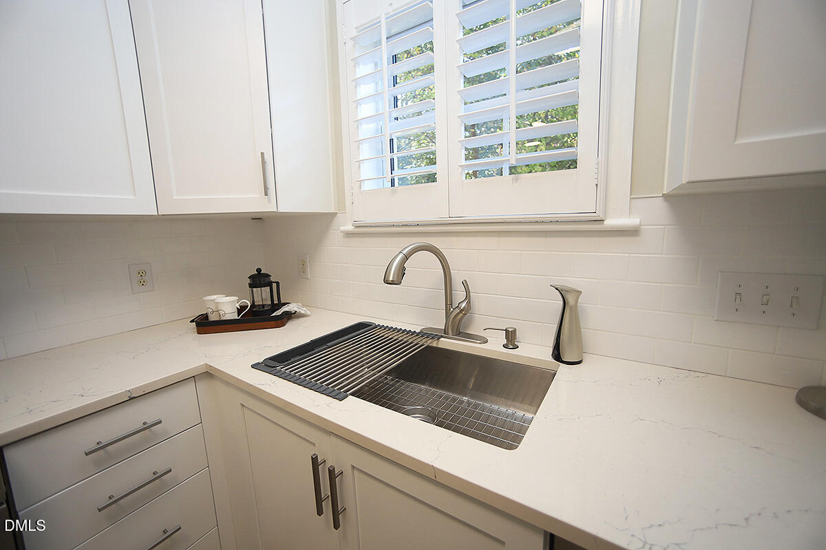 100 Northbrook Drive, Unit 207 Raleigh, NC 27609 - Photo 16 of 39 a kitchen with a sink and cabinets